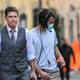 An unmasked Tom Cruise on the set of Mission: Impossible 7 along with a number of unmasked crewmembers.